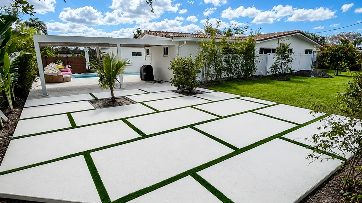 Completed concrete patio with artificial turf lines